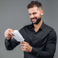 Thumbnail for Man unboxing a gift of the Unique Initial Necklace by Brother & Sisters, showcasing its stylish design.