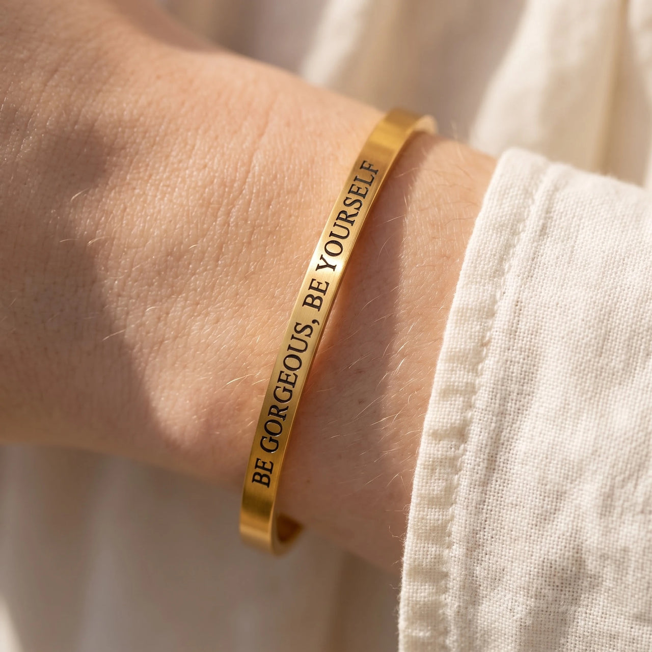 Close-up of the Be Gorgeous, Be Yourself bracelet in gold worn | SKU: bgby-g