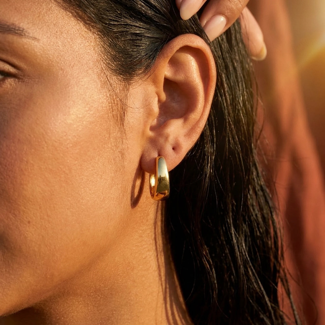 Chunky Dome Hoops in Gold, close-up on the earlobe | SKU: 41005-gold