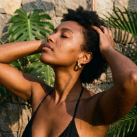 Thumbnail for Chunky Dome Hoops in Gold, worn in a tropical outdoor shower | SKU: 41005-gold