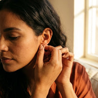 Thumbnail for Pave Huggie Hoop Earrings in Gold, being put on | SKU: 41011-gold