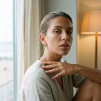 Thumbnail for Pave Huggie Hoop Earrings in Silver, worn by a window | SKU: 41011-silver