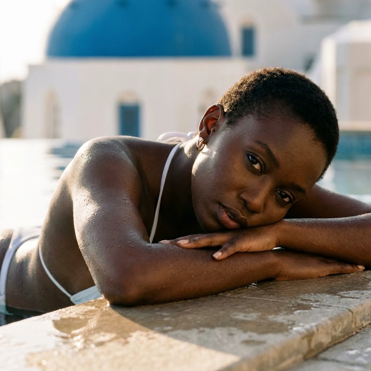 Pear Crystal Huggie Hoops in Gold, worn by a pool in Santorini | SKU: 41007-gold