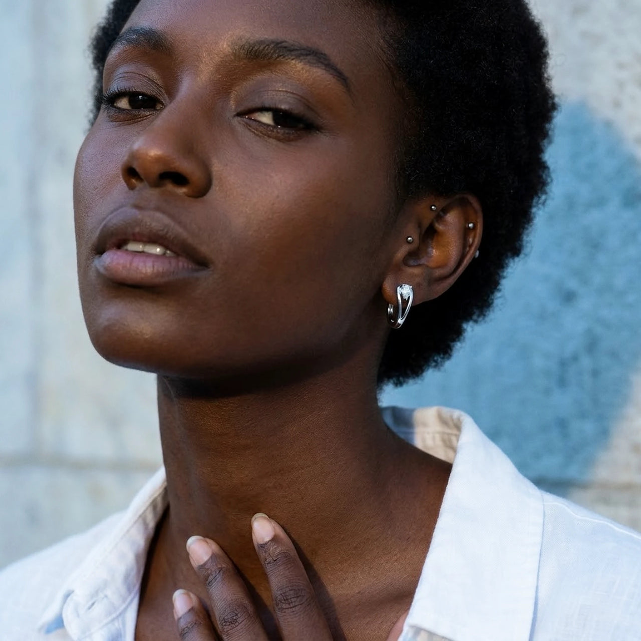 Pear Crystal Huggie Hoops in Silver, worn, close-up | SKU: 41007-silver