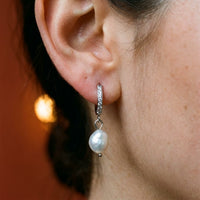 Thumbnail for Pearl Drop Huggie Hoops in Silver, close-up on the earlobe | SKU: 41003-silver