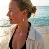 Thumbnail for Pearl Drop Huggie Hoops in Silver, worn on the beach | SKU: 41003-silver