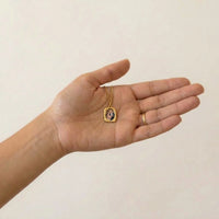 Thumbnail for Gold oval pendant resting in her palm, real small size, her parents' photo inside | SKU: TPH-OVLN-GOLD