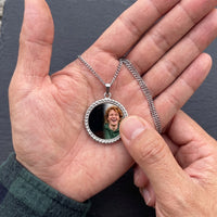 Thumbnail for Thumb warming the silver round pendant: the hidden photo appears under the thumb while the rest stays black | SKU: TPH-RNDN-SILVER