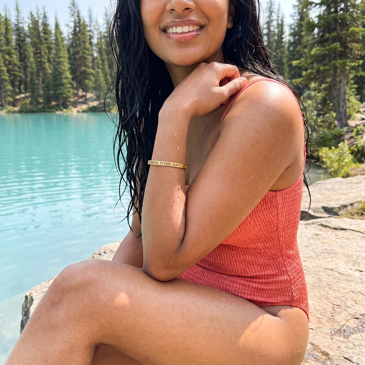 Travel To Feel Alive bracelet in gold worn by the water | SKU: ttfa-g