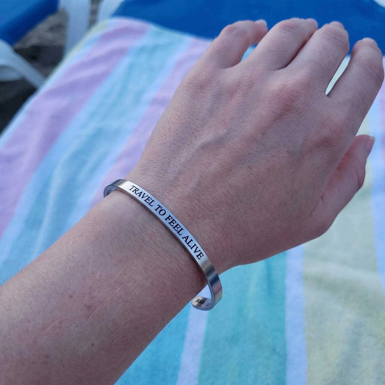 Travel To Feel Alive bracelet in silver worn, showing its real size | SKU: ttfa-wg