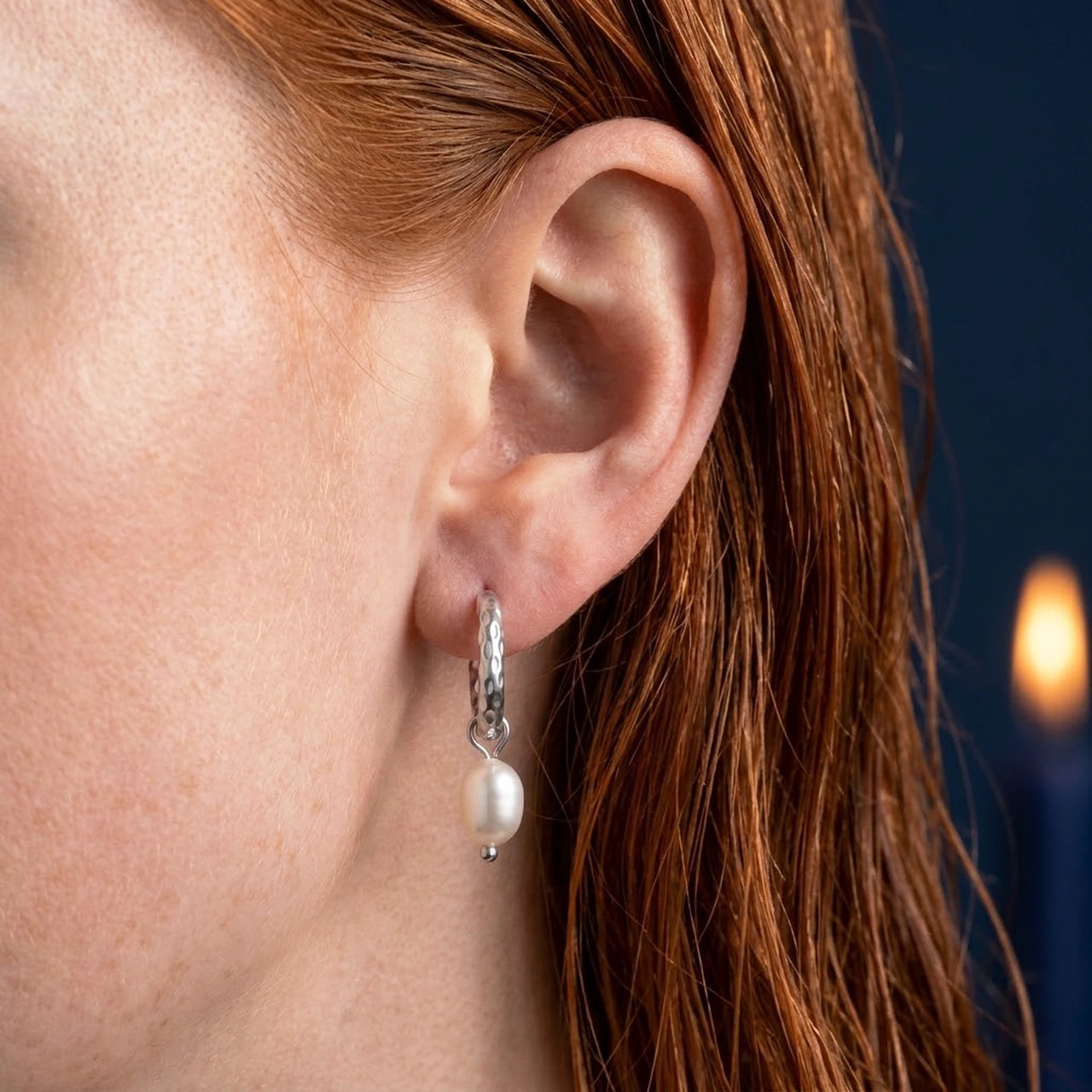 Twisted Pearl Drop Hoops in Silver, close-up on the earlobe | SKU: 41004-silver