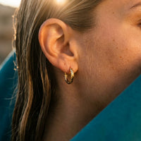 Thumbnail for Twisted Rope Huggie Hoops in Gold, close-up on the earlobe | SKU: 41012-gold